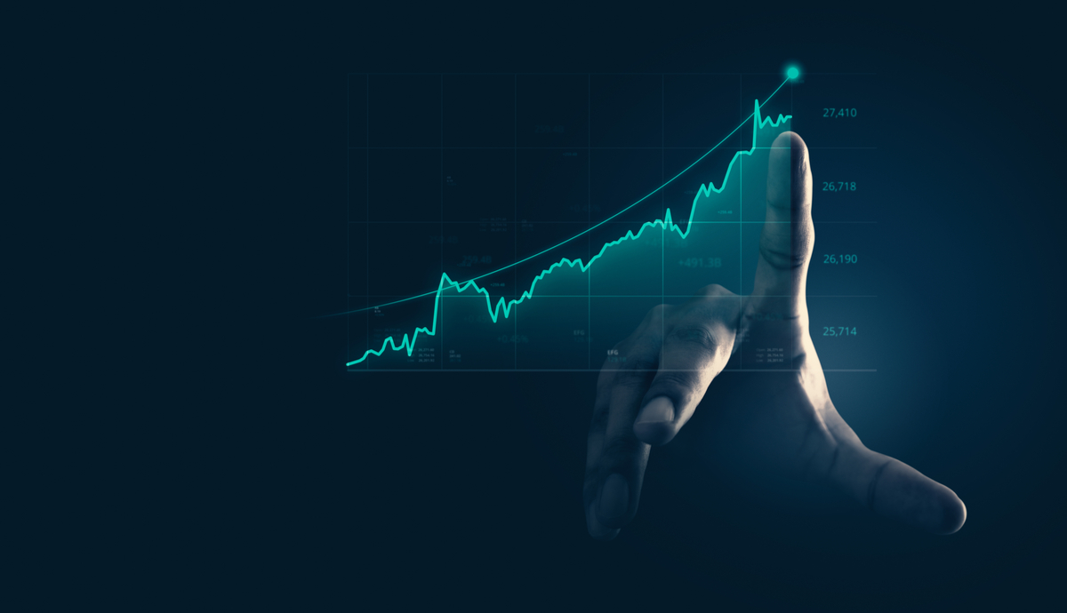 Dedo apontando para um gráfico de trading