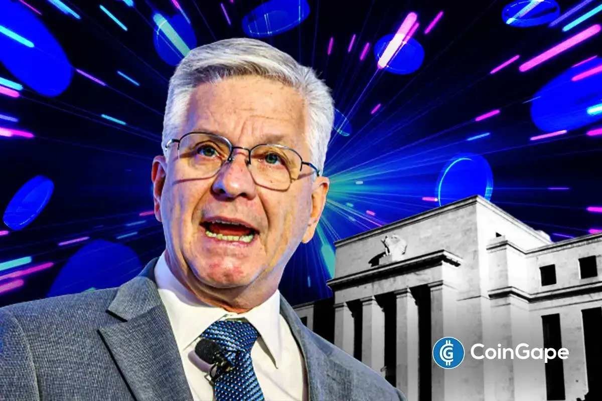 Chris Waller image while speaking on blockchain with Federal Reserve building in background