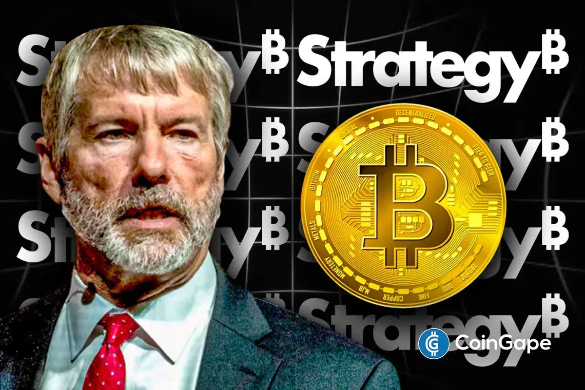 Michael Saylor stands beside a large Bitcoin symbol as Strategy signals strong commitment to expanding its BTC holdings.
