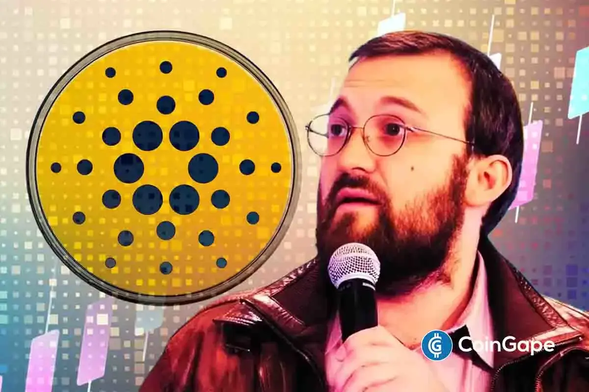 Charles Hoskinson speaks into a microphone beside the Cardano logo during network slowdown discussions.